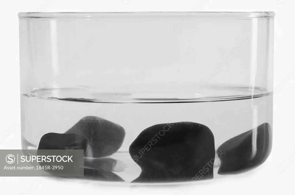 Close-up of stones sunk in a bowl of water
