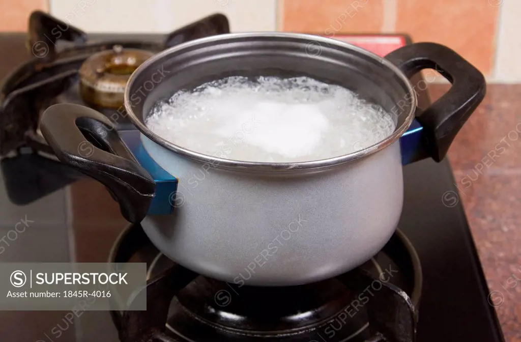 Rice boiling in a pan on a stove