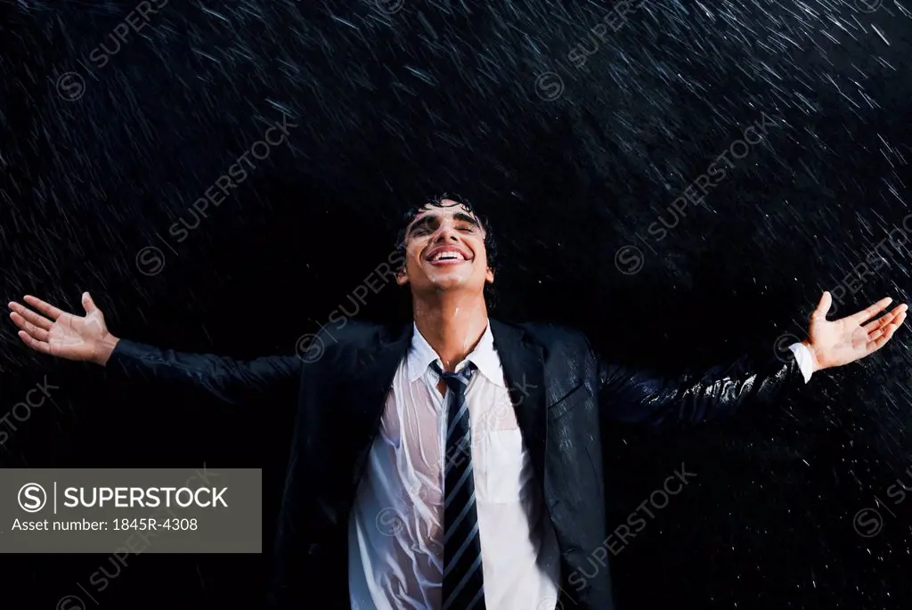 Businessman enjoying in the rain
