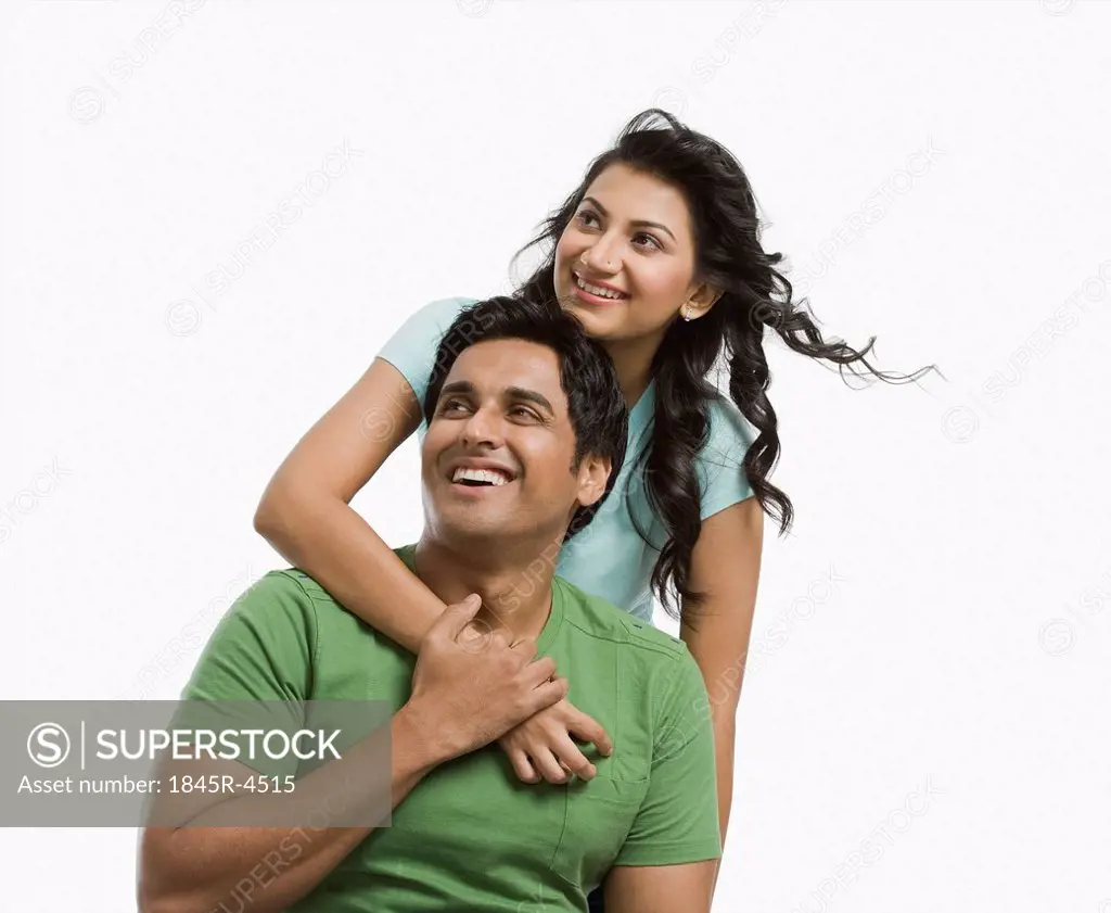 Woman hugging her husband from behind