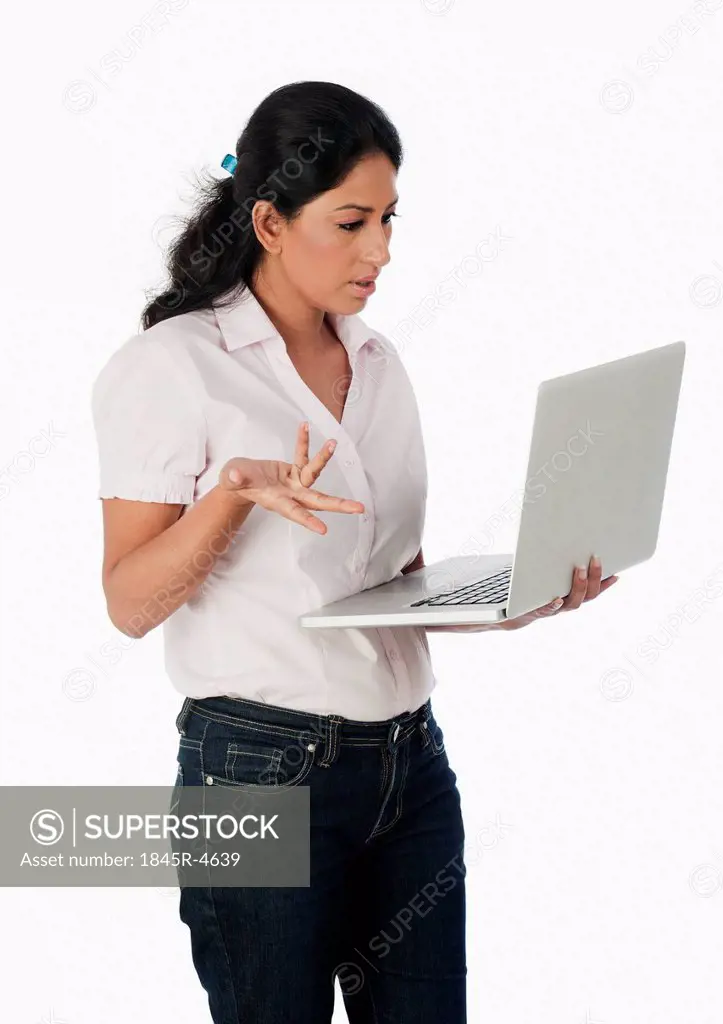Woman using a laptop and gesturing