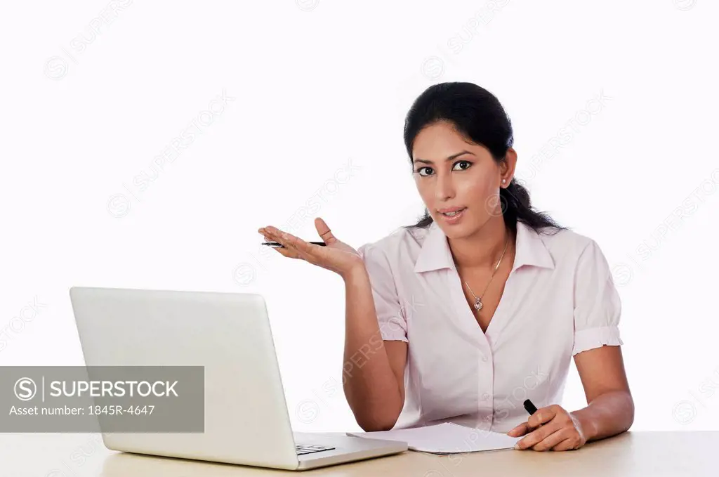 Woman using a laptop and gesturing