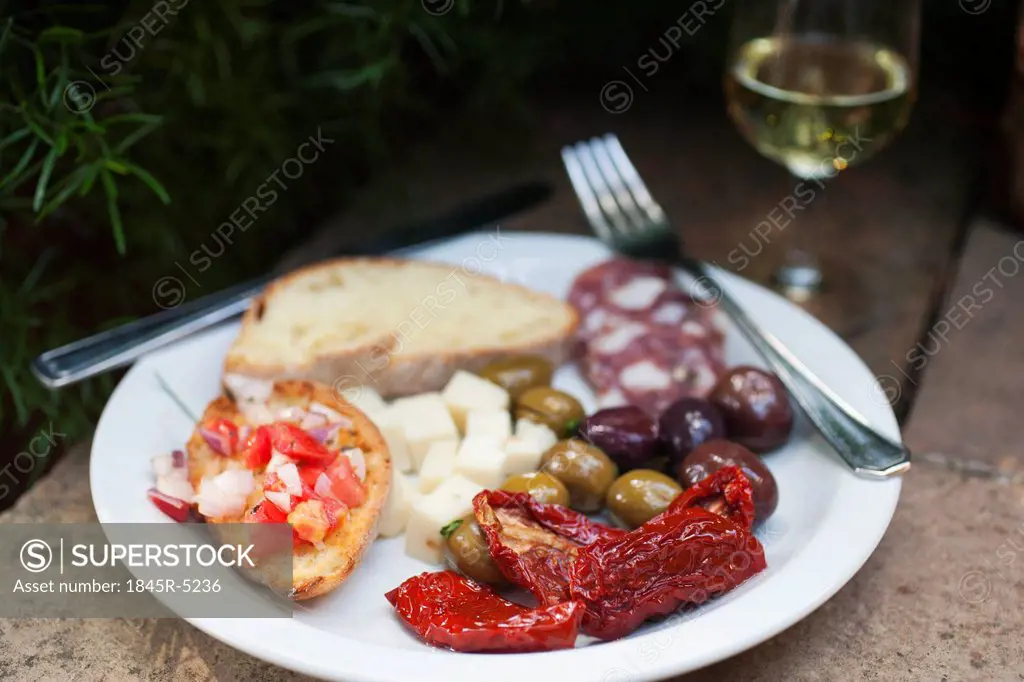Meal served on a plate with a wineglass, Italy