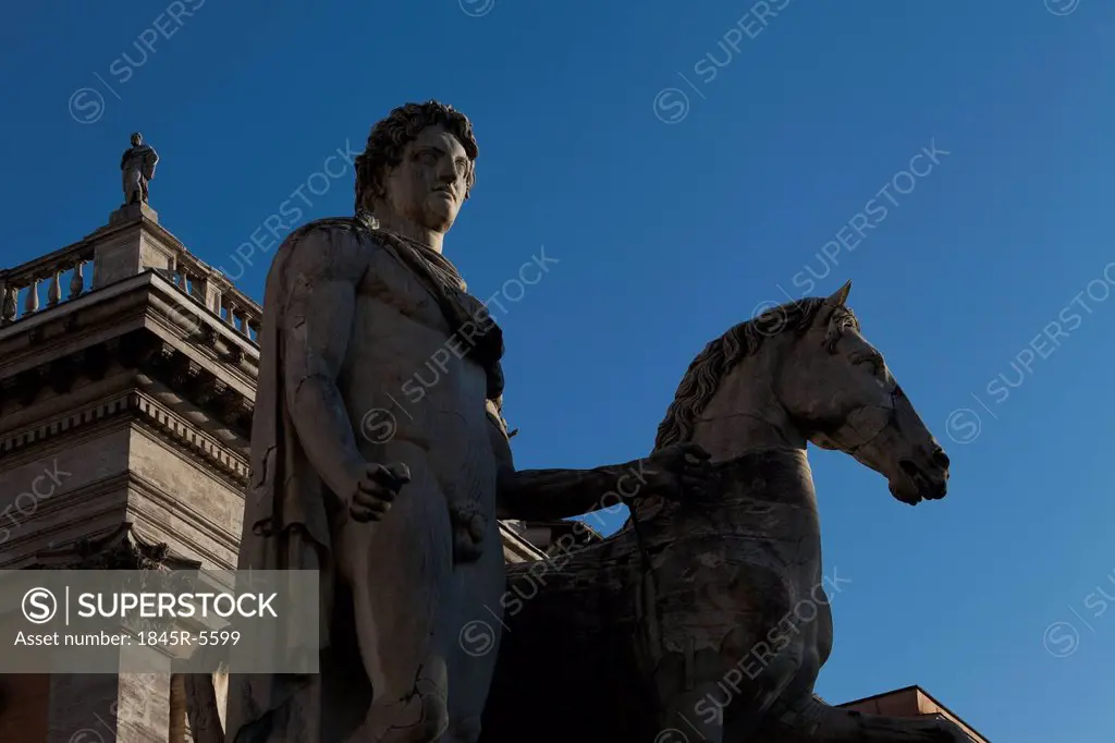 Low angle view of statues of man and horse, Rome, Lazio, Italy