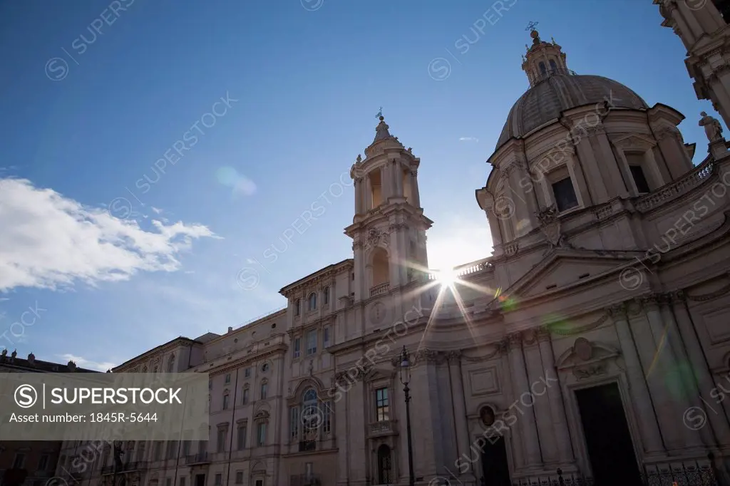 Sun shining behind a church, Church of SantAgnese in Agone, Piazza Navona, Rome, Lazio, Italy