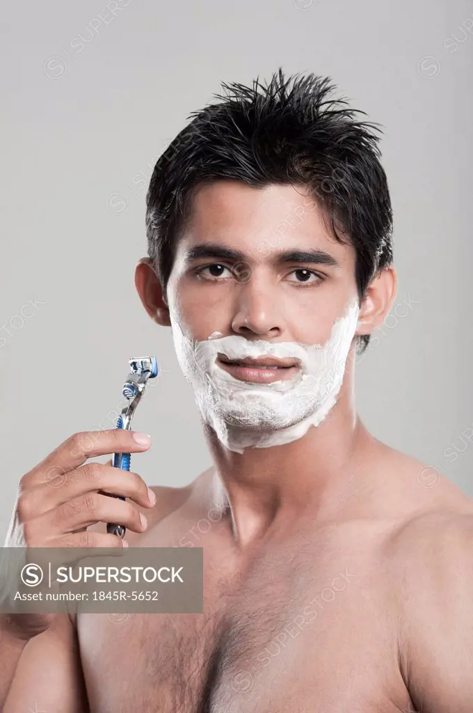 Portrait of a man shaving