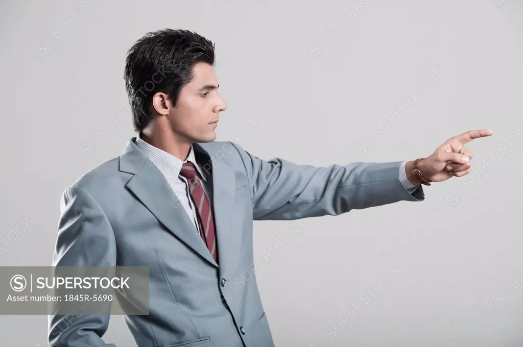 Businessman pointing away with finger