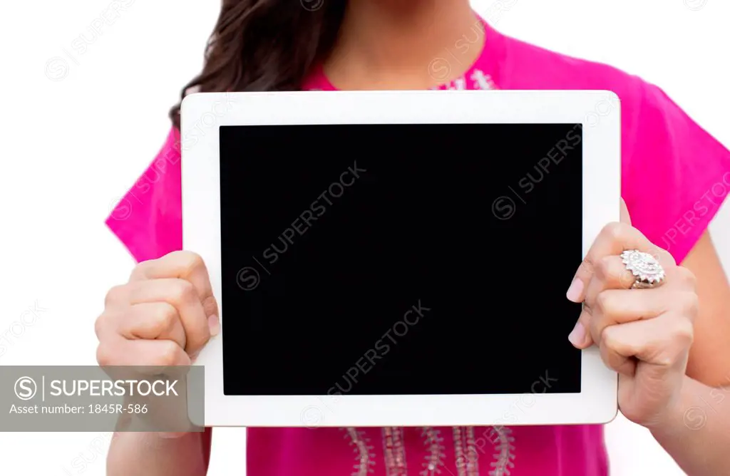 Mid section view of a woman showing a digital tablet