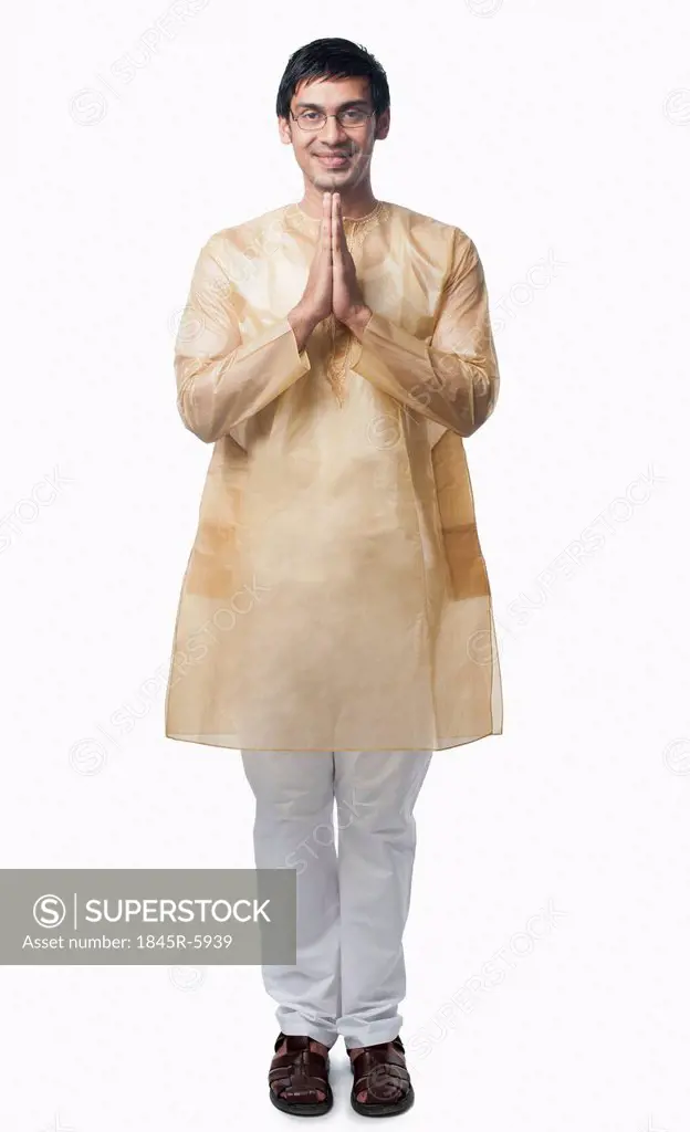 Bengali man standing in a prayer position