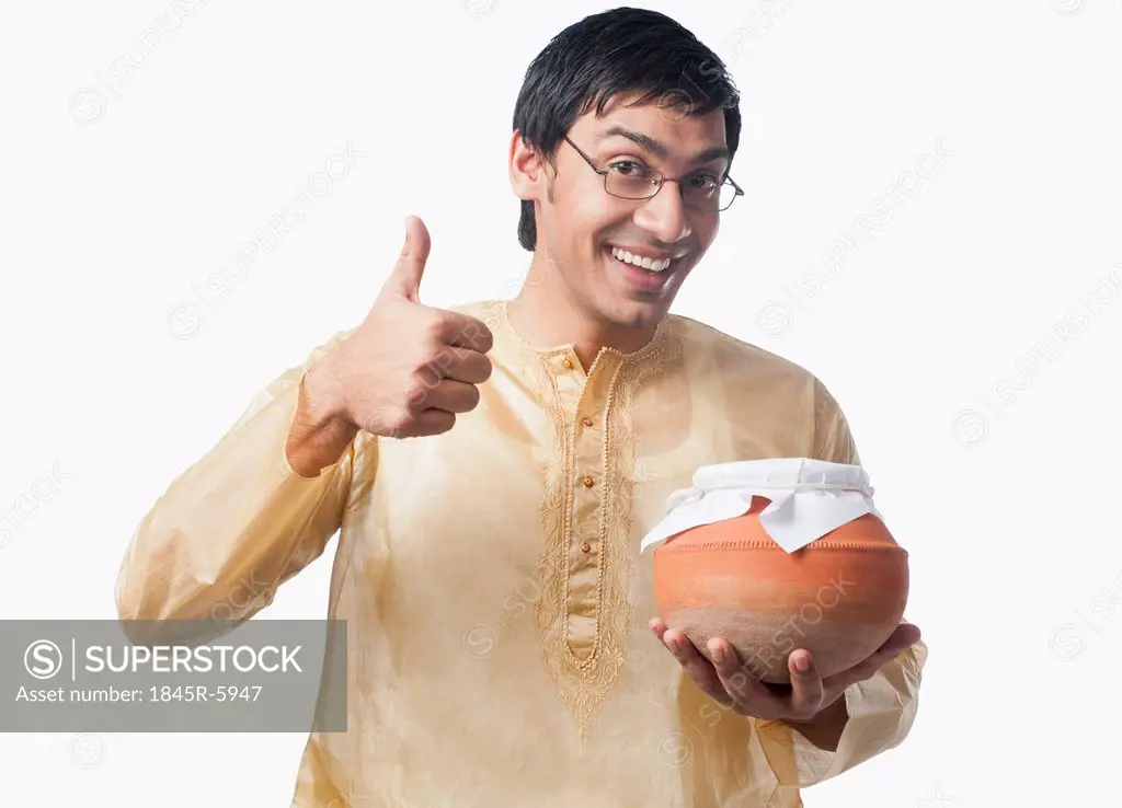Bengali man holding a pot of rasgulla and showing thumbs up sign