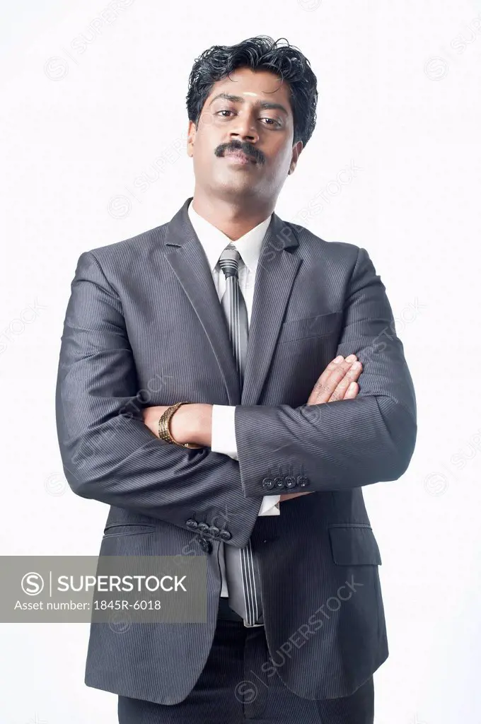 South Indian businessman standing with his arms crossed
