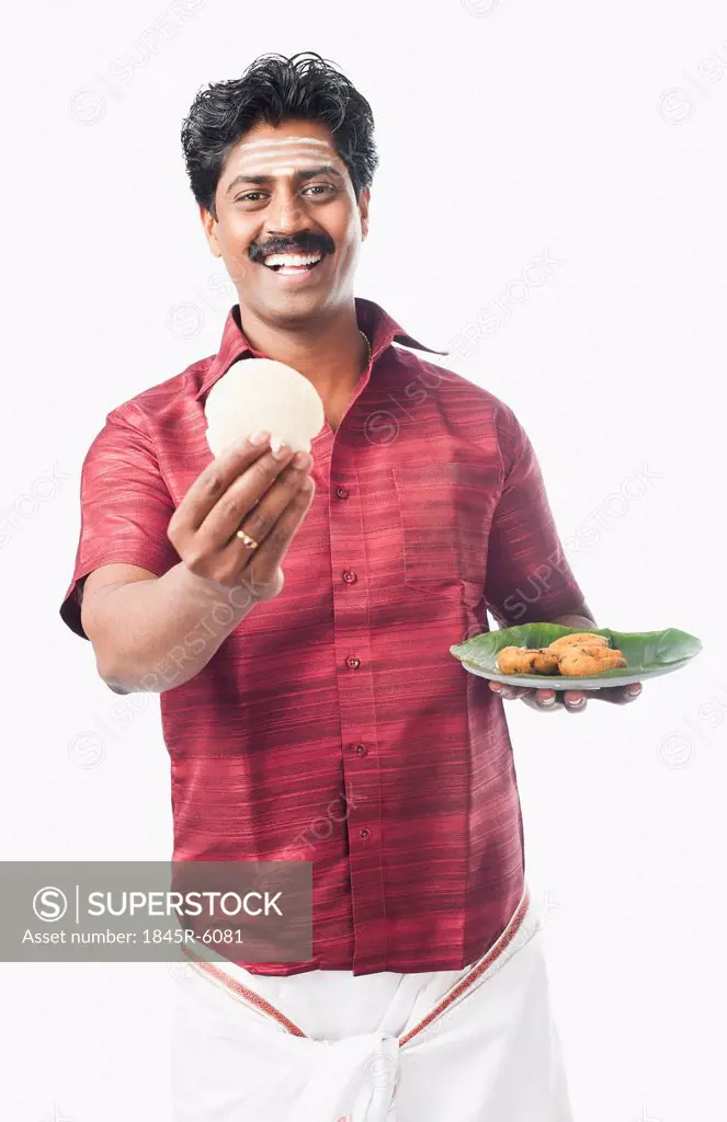 South Indian man having idli