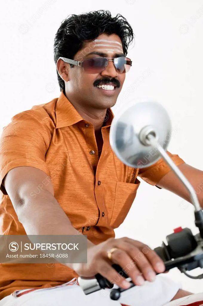 South Indian man riding a motorcycle