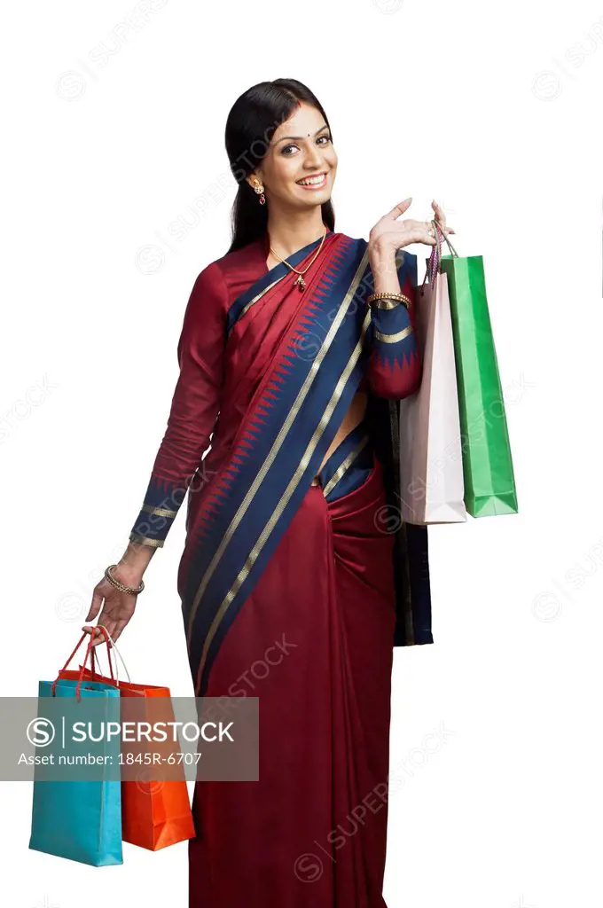 Traditionally Indian woman holding shopping bags