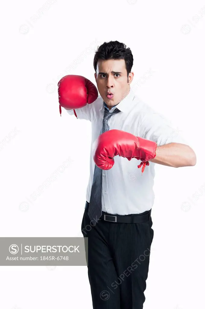 Portrait of a businessman wearing boxing gloves