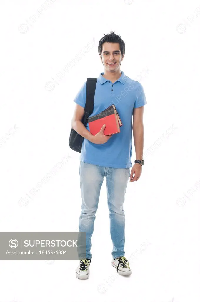 Portrait of an university student holding books and smiling