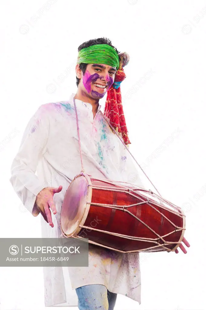 Man celebrating Holi with playing dholak