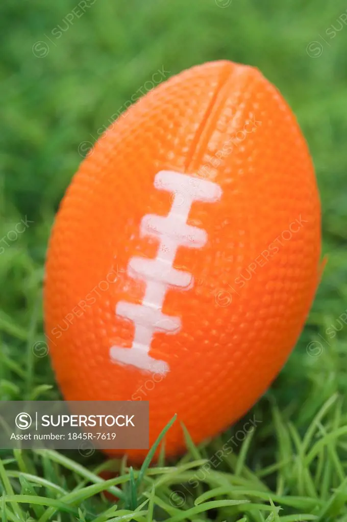 Close-up of an American football on grass
