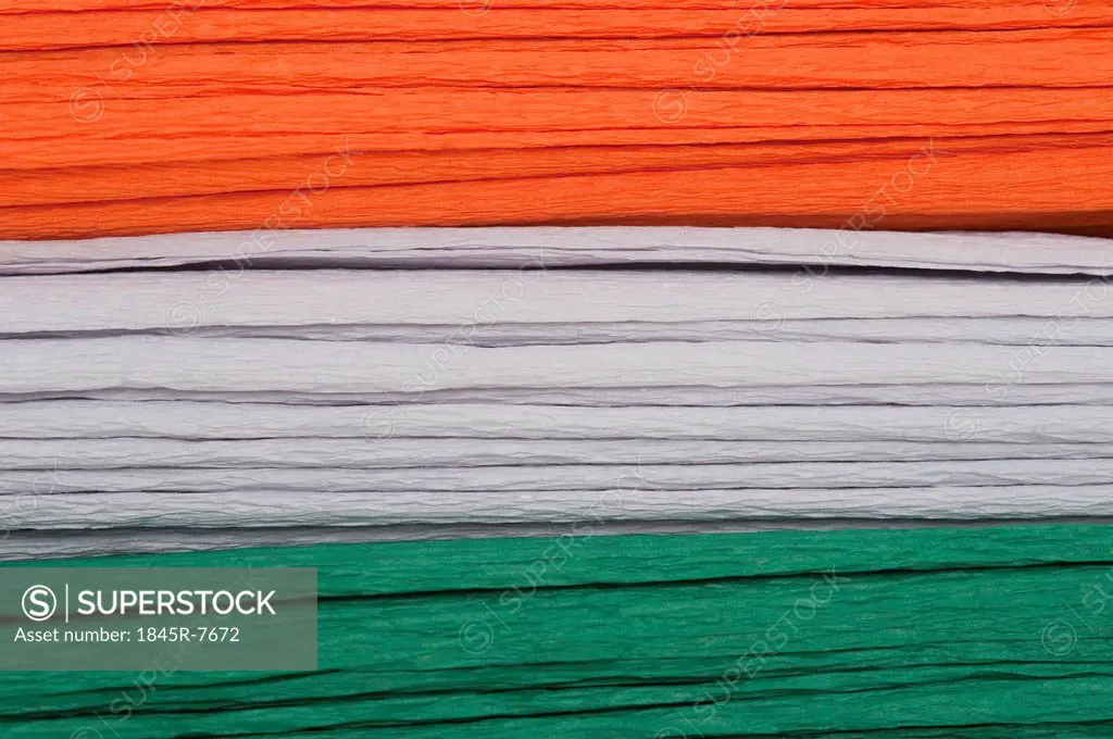 Close-up of a stack of colorful papers representing Indian flag colors