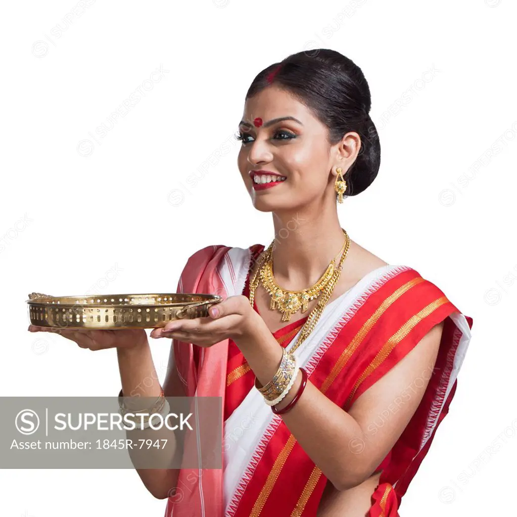 Traditional Bengali woman holding pooja thali