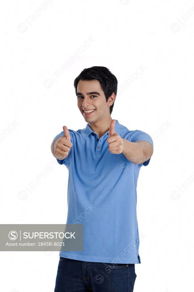 Portrait of a man showing thumbs up sign and smiling