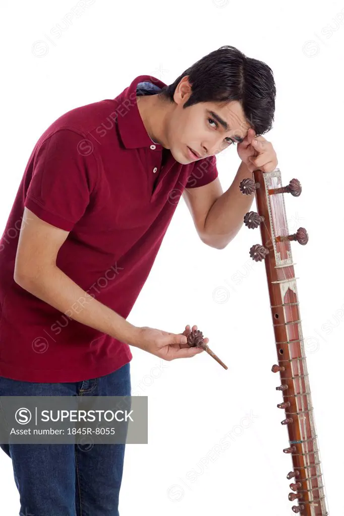 Man leaning over his broken sitar