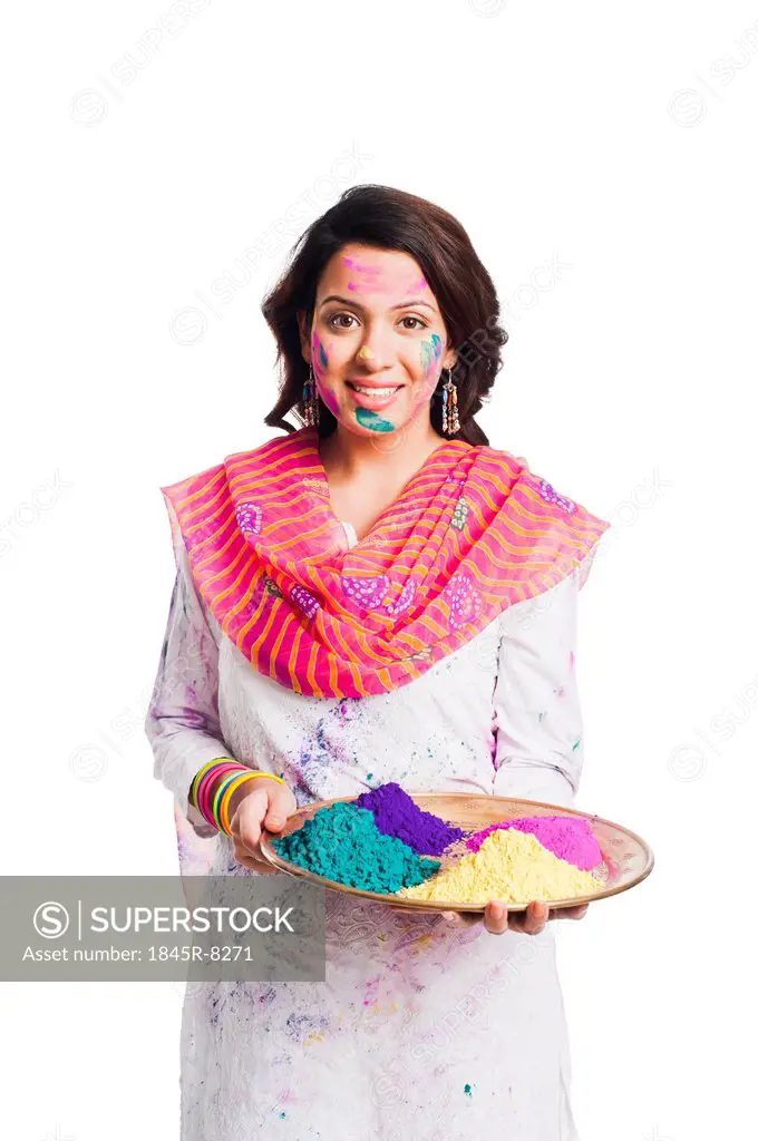 Woman holding Holi colors in a plate