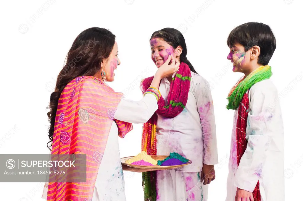 Woman celebrating Holi festival with her children