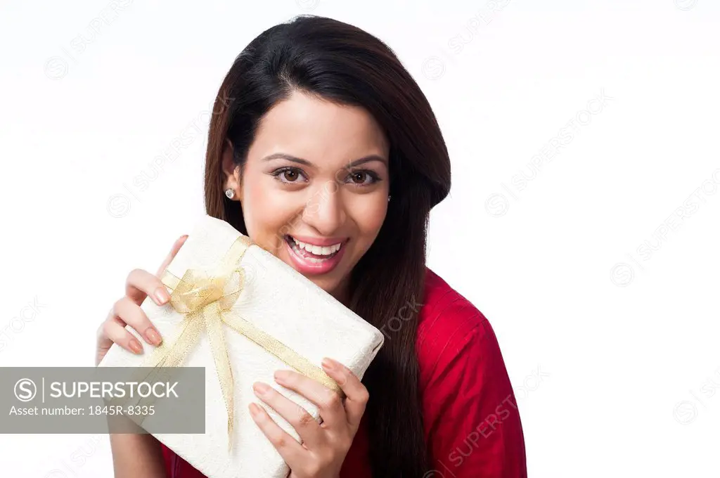 Portrait of a happy woman holding a gift box