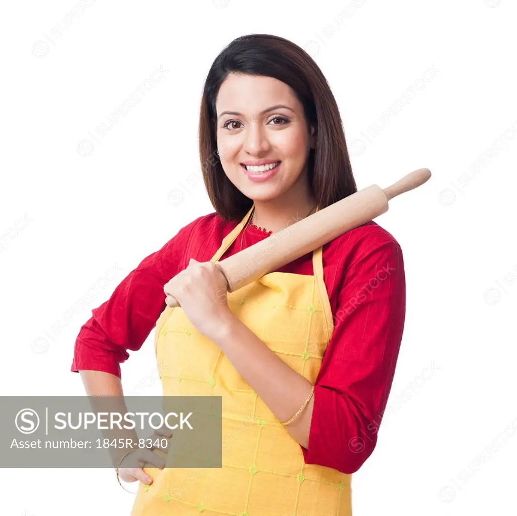 Portrait of a woman holding a rolling pin and smiling