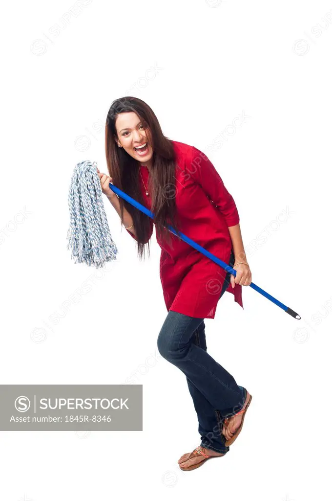Portrait of a happy woman posing with a mop