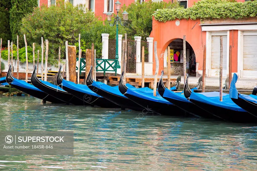 Gondolas anchored in a canal, Venice, Veneto, Italy