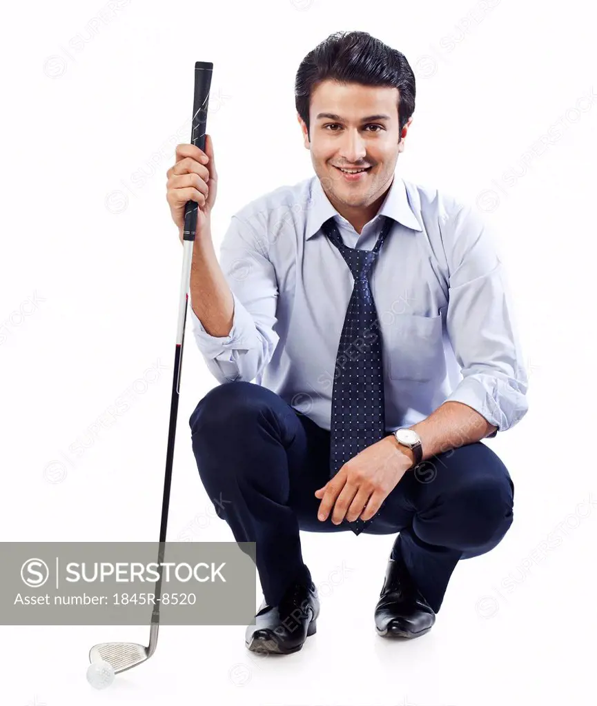 Portrait of a businessman holding a golf club