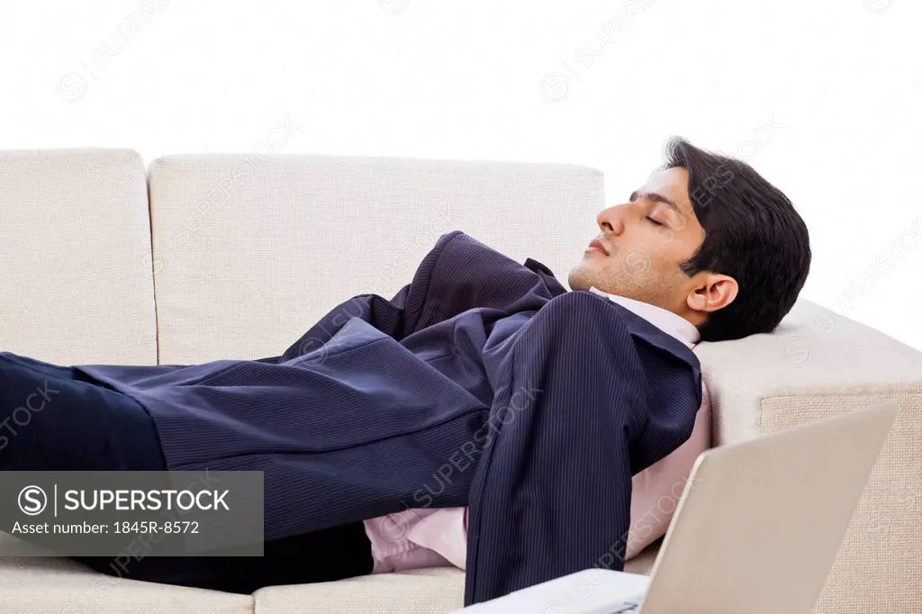 Businessman resting on a couch