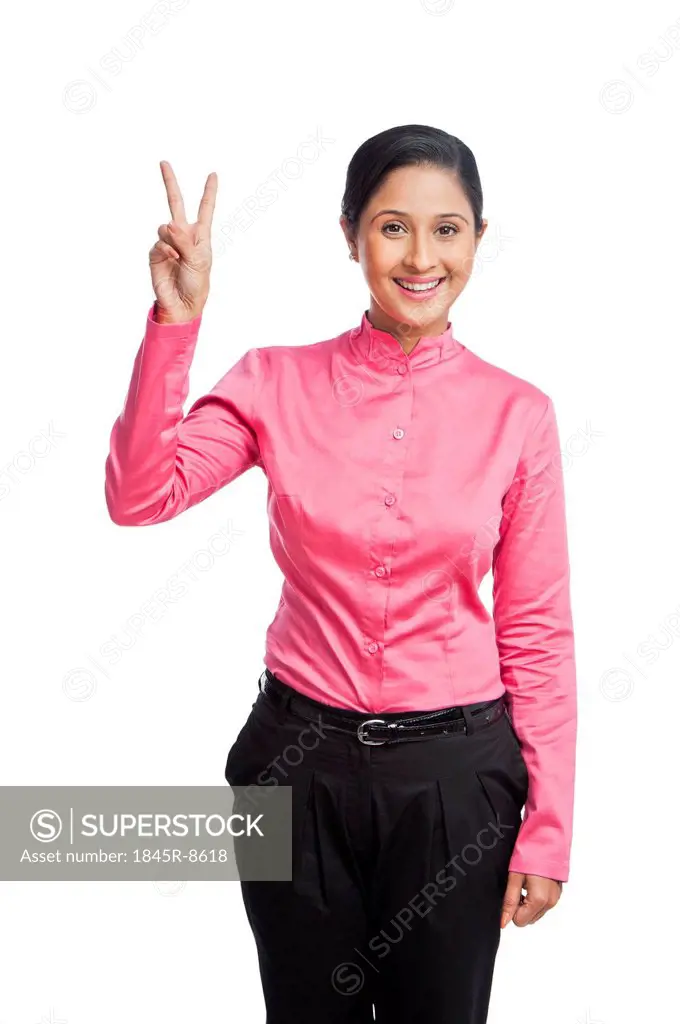 Portrait of a businesswoman gesturing victory sign
