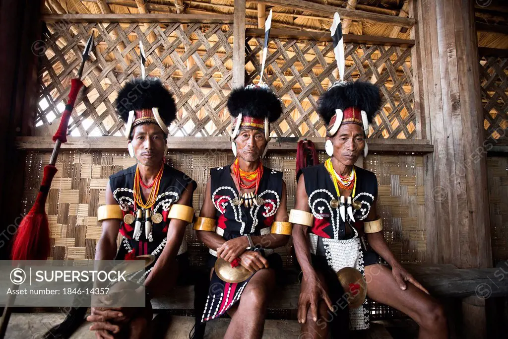 Naga tribal warriors in traditional outfit in a hut, Hornbill Festival, Kohima, Nagaland, India