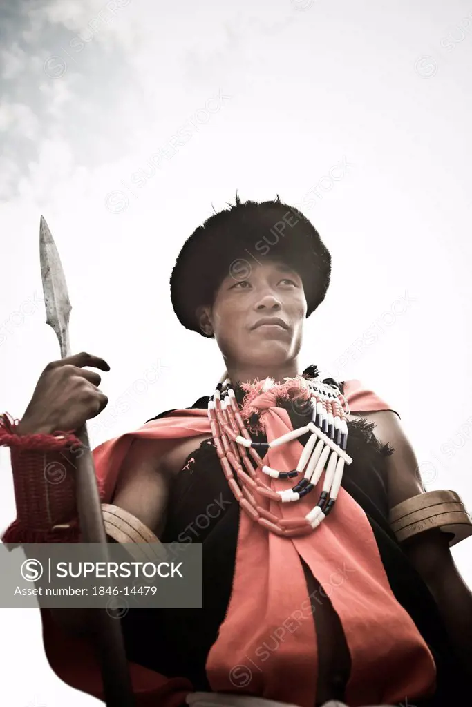 Naga tribal warrior in traditional outfit with spear, Hornbill Festival, Kohima, Nagaland, India