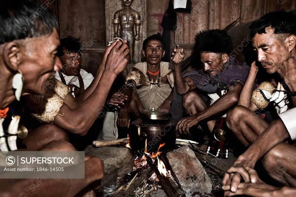 Naga tribal men cooking food in a kitchen, Hornbill Festival, Kohima, Nagaland, India