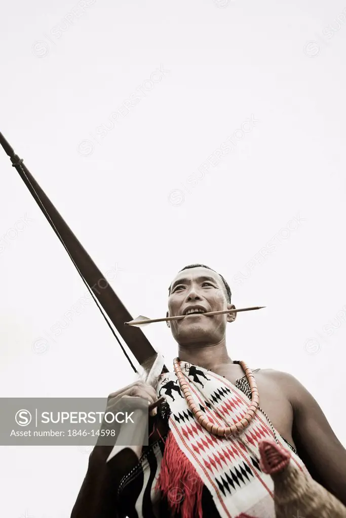 Naga tribal warrior holding a cross bow, Hornbill Festival, Kohima, Nagaland, India