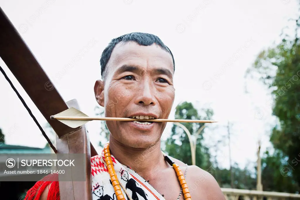 Naga tribal warrior holding a cross bow, Hornbill Festival, Kohima, Nagaland, India