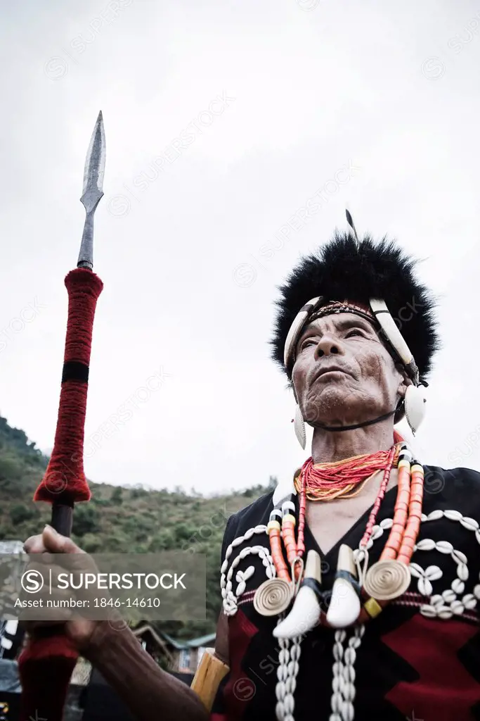 Naga tribal warrior standing with spear, Hornbill Festival, Kohima, Nagaland, India