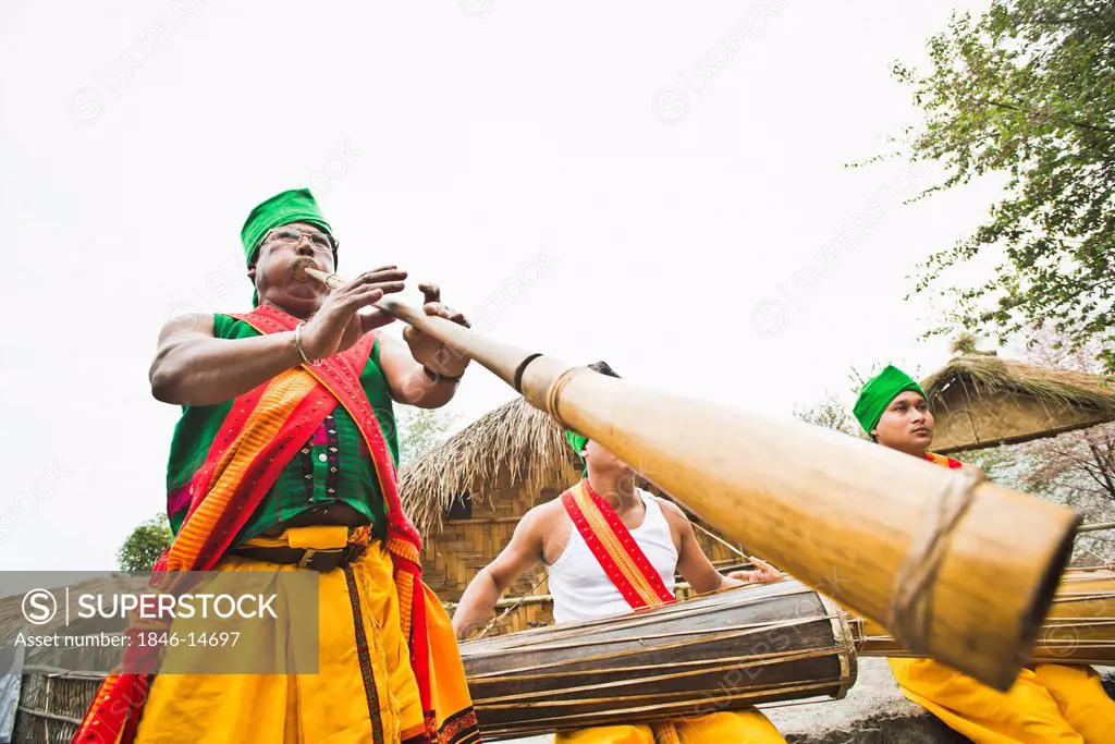 Naga tribal men playing traditional musical instruments, Hornbill Festival, Kohima, Nagaland, India