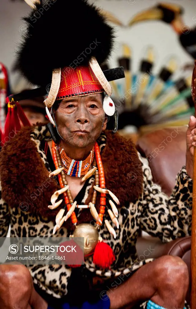 Elderly Naga tribesman in traditional outfit during the annual Hornbill Festival at Kisama, Kohima, Nagaland, India