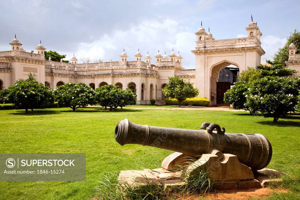 Cannon in the lawn with palace in the background, Chowmahalla Palace, Hyderabad, Andhra Pradesh, India