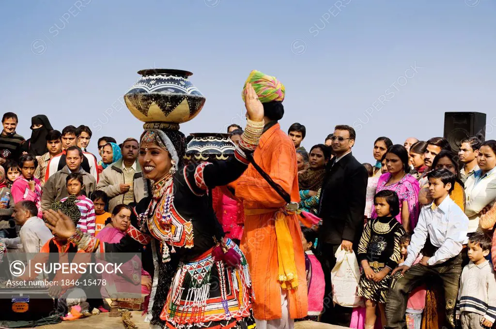People in traditional Rajasthani dress performing kalbelia dance in Surajkund Mela, Faridabad, Haryana, India