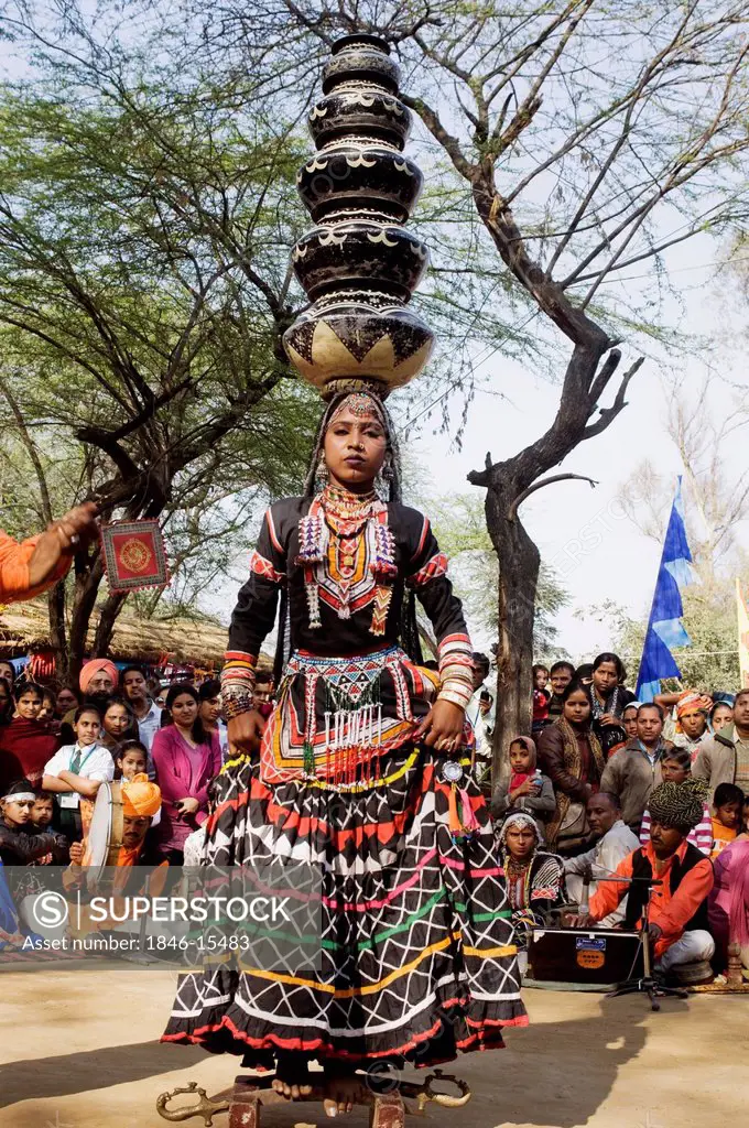 Woman in traditional Rajasthani dress performing kalbelia dance in Surajkund Mela, Faridabad, Haryana, India