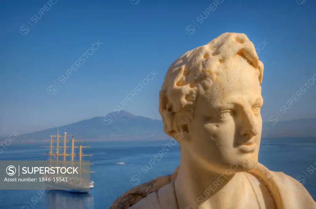 Close-up of a bust with sailing ship in the sea in background, Sorrento, Campania, Italy