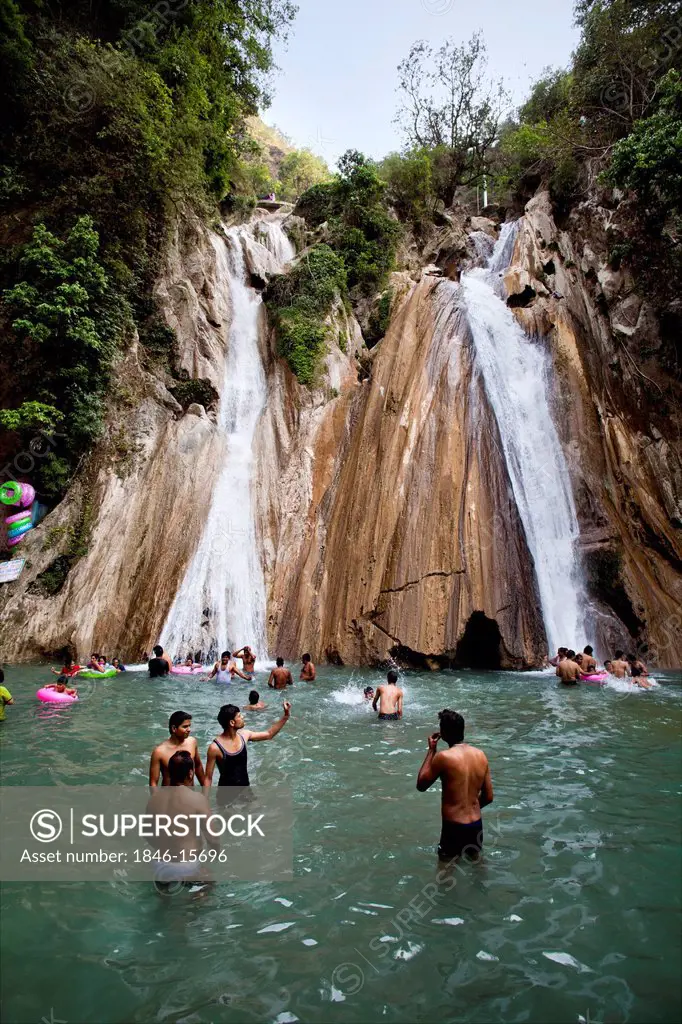 Tourists enjoying at waterfall, Kempty Falls, Chakrata Road, Mussoorie, Uttarakhand, India