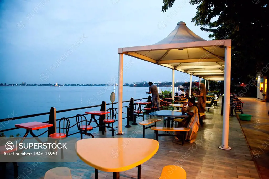 Tourists at lakeside restaurant, Eat Street, Hyderabad, Andhra Pradesh, India