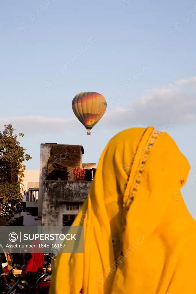 Hot air balloon in flight over buildings, Pushkar, Ajmer, Rajasthan, India